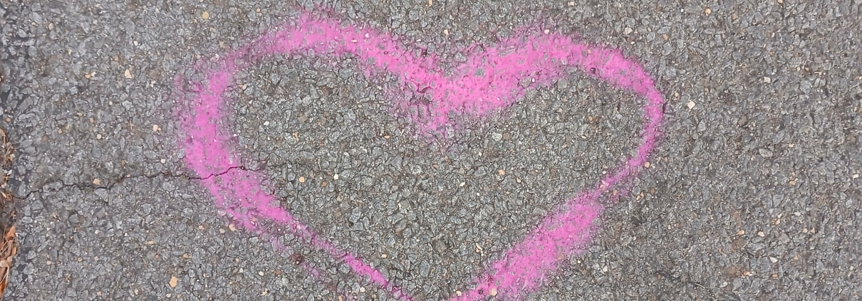 Heart In Parking Lot Pink heart drawn on tarmac in a parking lot