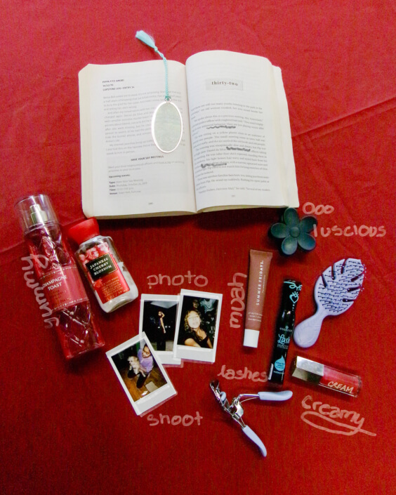 A book, personal care item, and photos on a dramatic red background.
