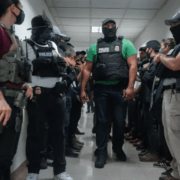 Masked federal agents wait outside an immigration courtroom, July 8, 2025, in New York. (AP Photo/Olga Fedorova)