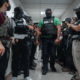 Masked federal agents wait outside an immigration courtroom, July 8, 2025, in New York. (AP Photo/Olga Fedorova)