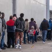 Asylum seekers queue at the entrance of Mexico's Refugee Help Commission and UNHCR offices in Tijuana, Mexico on January 24, 2025. Guillermo Arias/AFP via Getty Images