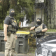 Two masked officers shown in Eddyville, NY, in July 2026.